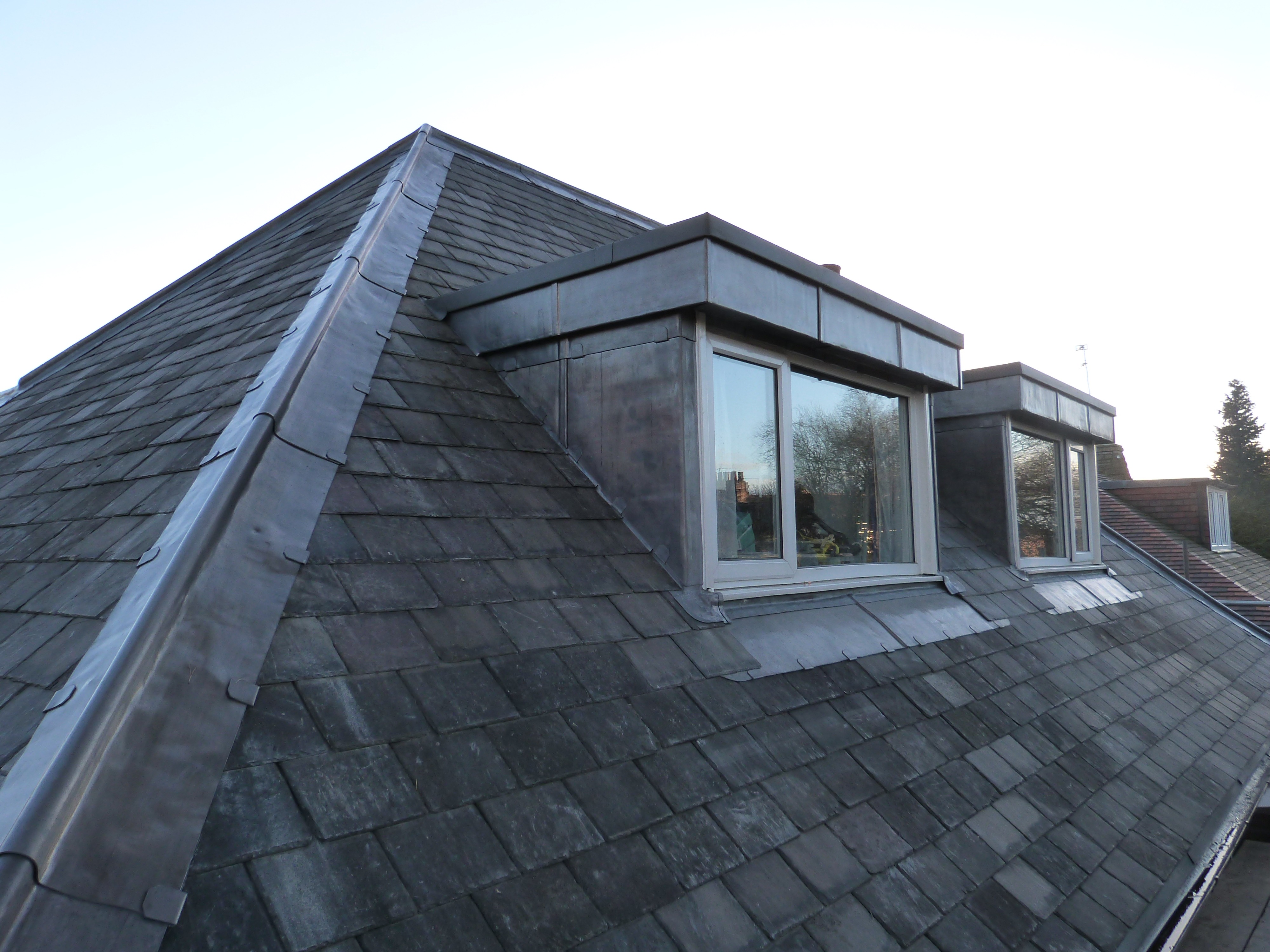 Finished roof replacement project showing completed roof coverings